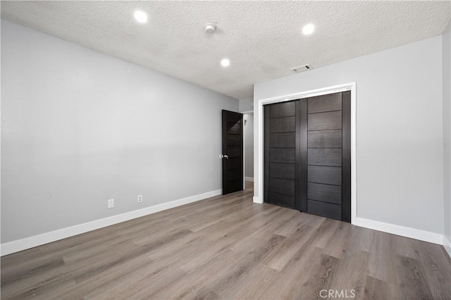 18561 Bert Rd, Riverside, CA 92508 - unfurnished bedroom featuring wood finished floors, recessed lighting, a textured ceiling, and a closet