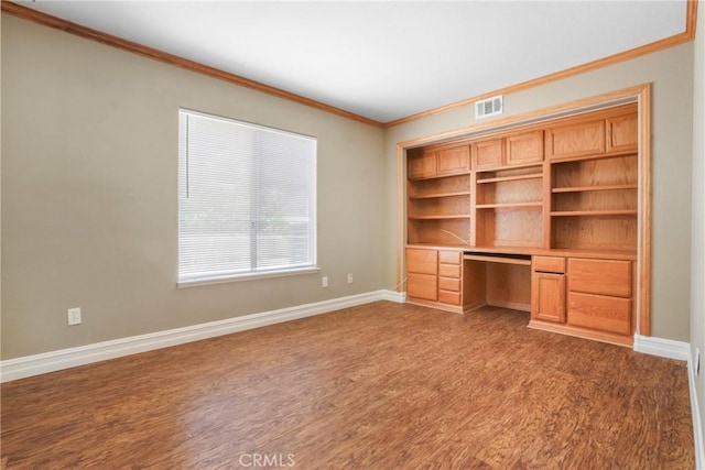 31752 Poole Ct, Temecula, CA 92591 - unfurnished office featuring built in desk, crown molding, and dark wood-style flooring