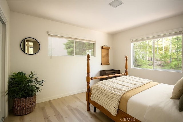 27984 St Bernard Ln, Lake Arrowhead, CA 92352 - bedroom with light wood-style flooring and multiple windows