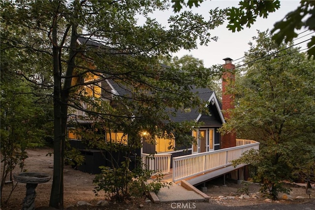 27984 St Bernard Ln, Lake Arrowhead, CA 92352 - back of house featuring a wooden deck and a chimney