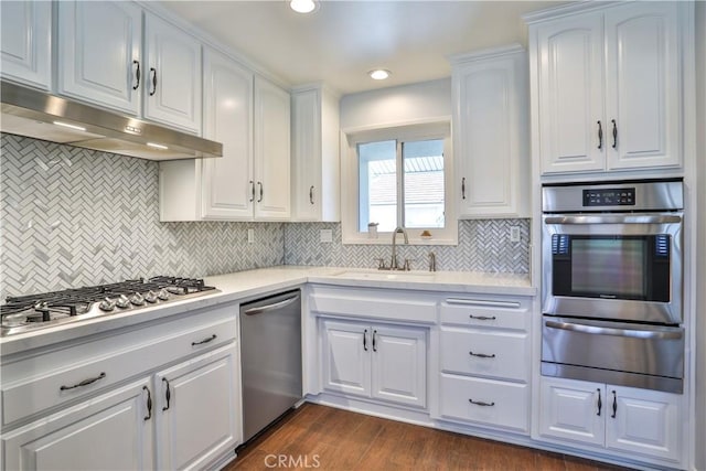12682 Saint Mark St, Garden Grove, CA 92845 - kitchen featuring a warming drawer, appliances with stainless steel finishes, under cabinet range hood, white cabinetry, and backsplash