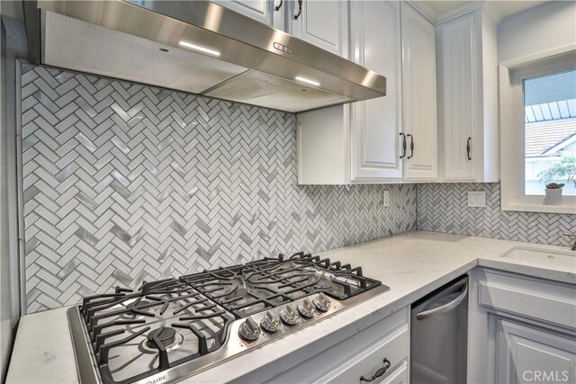 12682 Saint Mark St, Garden Grove, CA 92845 - kitchen featuring under cabinet range hood, appliances with stainless steel finishes, backsplash, white cabinetry, and light stone countertops