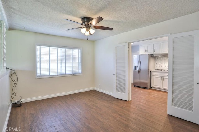 12682 Saint Mark St, Garden Grove, CA 92845 - unfurnished bedroom with stainless steel refrigerator with ice dispenser, dark wood-style flooring, a textured ceiling, and ceiling fan