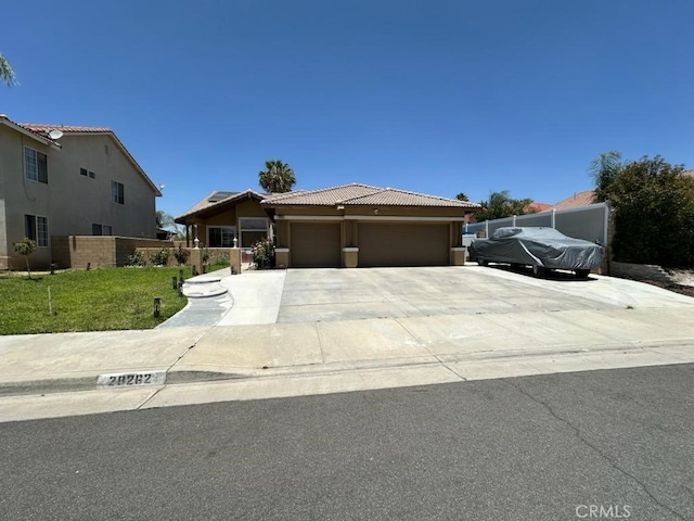 28262 Cider, Menifee, CA 92585 - view of front of house with a tile roof, an attached garage, driveway, and stucco siding
