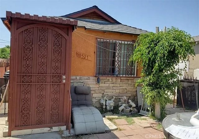10527 Croesus Ave, Los Angeles, CA 90002 - view of home's exterior featuring stone siding and stucco siding