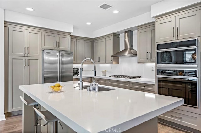 1309 Doheny Way, Dana Point, CA 92629 - kitchen with stainless steel appliances, wall chimney range hood, gray cabinetry, light countertops, and recessed lighting