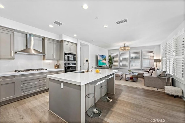 1309 Doheny Way, Dana Point, CA 92629 - kitchen featuring gray cabinets, wall chimney exhaust hood, appliances with stainless steel finishes, open floor plan, and recessed lighting