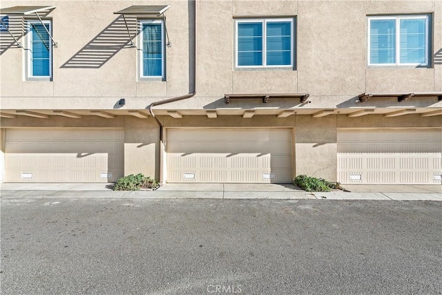 1309 Doheny Way, Dana Point, CA 92629 - view of property featuring stucco siding and a garage