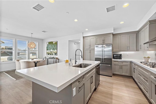 1309 Doheny Way, Dana Point, CA 92629 - kitchen with stainless steel appliances, gray cabinetry, light wood finished floors, and recessed lighting