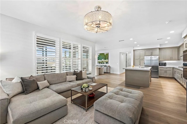 1309 Doheny Way, Dana Point, CA 92629 - living area with light wood-style flooring, a chandelier, and recessed lighting