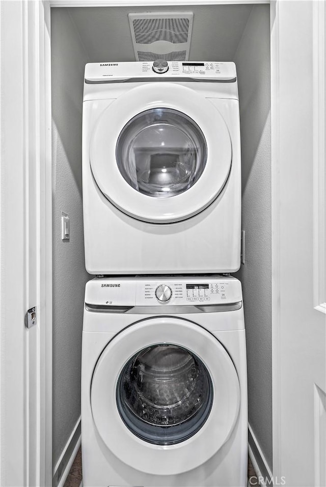 1309 Doheny Way, Dana Point, CA 92629 - laundry room featuring stacked washer and clothes dryer and baseboards