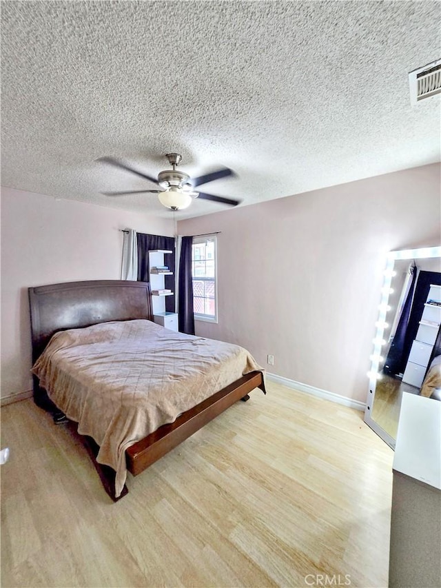 9313 Dearborn Ave, South Gate, CA 90280 - bedroom featuring light wood-style flooring, ceiling fan, and a textured ceiling