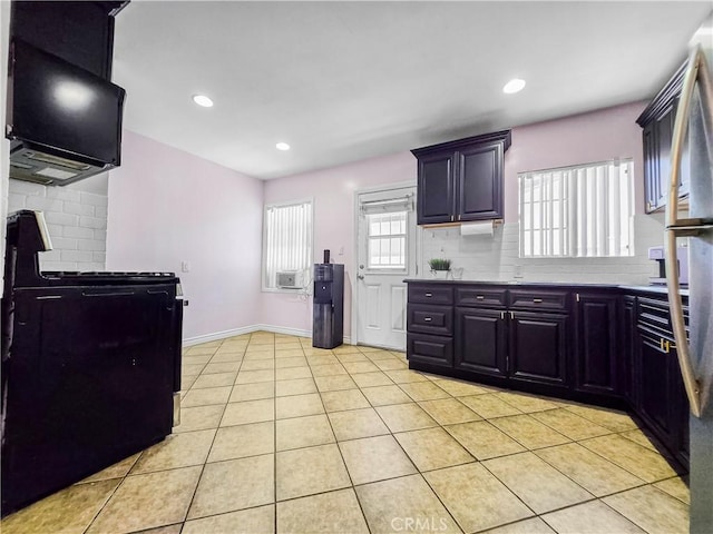 9313 Dearborn Ave, South Gate, CA 90280 - kitchen with light tile patterned floors, tasteful backsplash, stove, light countertops, and recessed lighting