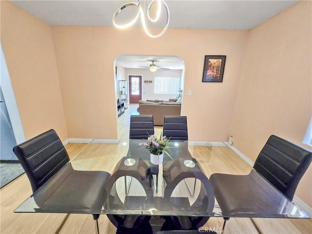 9313 Dearborn Ave, South Gate, CA 90280 - dining area featuring arched walkways, wood finished floors, and a chandelier
