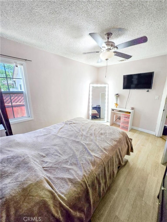 9313 Dearborn Ave, South Gate, CA 90280 - bedroom with a textured ceiling, wood finished floors, and a ceiling fan