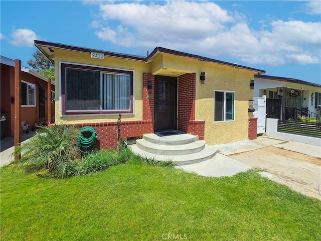 9313 Dearborn Ave, South Gate, CA 90280 - view of front of property featuring a front yard and stucco siding