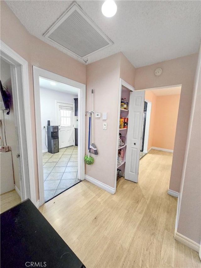 9313 Dearborn Ave, South Gate, CA 90280 - corridor featuring light wood finished floors