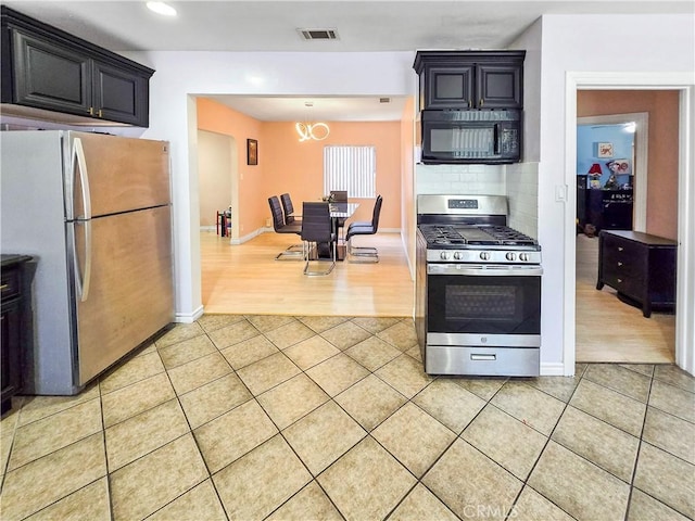 9313 Dearborn Ave, South Gate, CA 90280 - kitchen with appliances with stainless steel finishes, light tile patterned floors, decorative backsplash, a chandelier, and recessed lighting