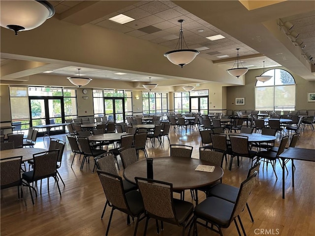 3110 Via Serena S Unit Q, Laguna Woods, CA 92637 - dining area with wood finished floors, healthy amount of natural light, a paneled ceiling, and a towering ceiling