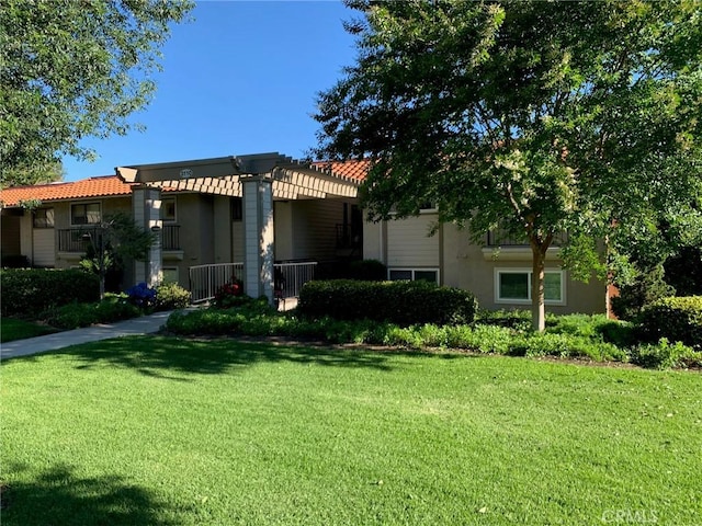 3110 Via Serena S Unit Q, Laguna Woods, CA 92637 - mediterranean / spanish-style home featuring a front lawn, a tile roof, and stucco siding