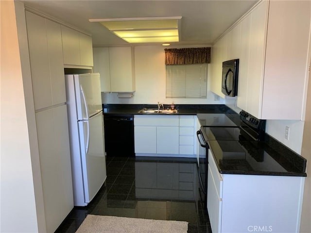 3110 Via Serena S Unit Q, Laguna Woods, CA 92637 - kitchen with black appliances, dark countertops, white cabinetry, and dark tile patterned floors