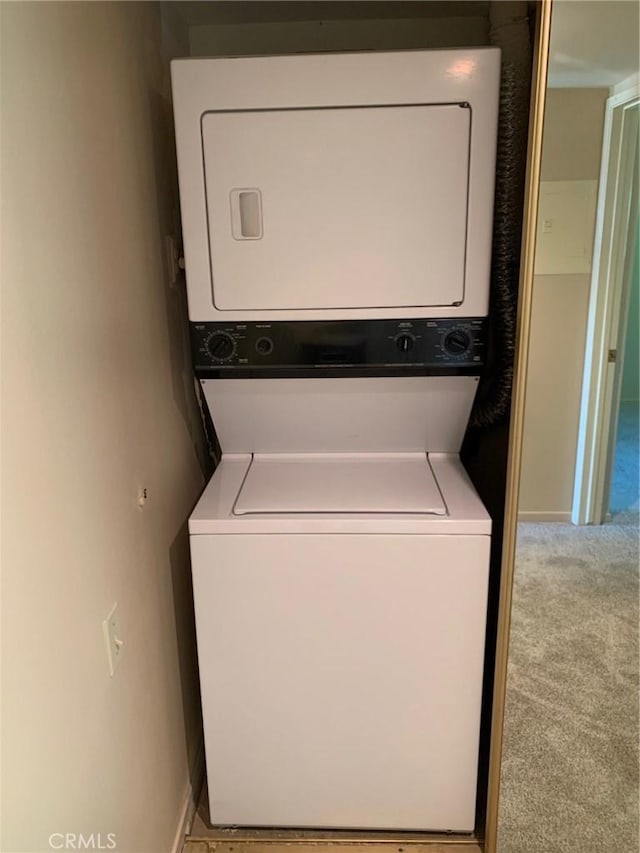 3110 Via Serena S Unit Q, Laguna Woods, CA 92637 - laundry room featuring stacked washer / dryer and carpet flooring