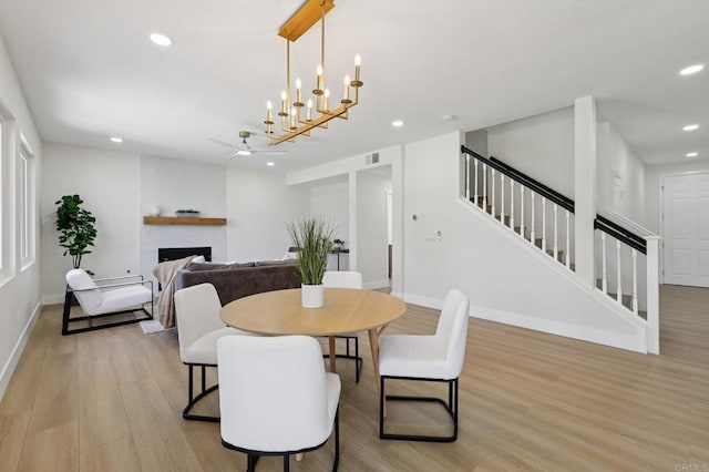 5471 Papagallo Dr, Oceanside, CA 92057 - dining space featuring stairs, light wood-style floors, recessed lighting, a fireplace, and ceiling fan