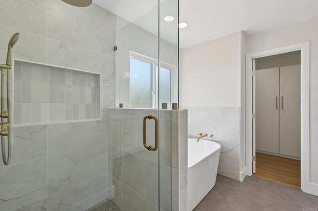 5471 Papagallo Dr, Oceanside, CA 92057 - full bath with a shower stall, tile walls, a freestanding bath, recessed lighting, and a wainscoted wall