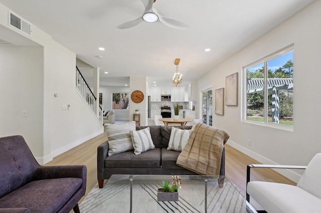 5471 Papagallo Dr, Oceanside, CA 92057 - living room with light wood-style floors, stairs, a chandelier, recessed lighting, and a ceiling fan