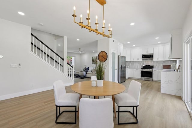 5471 Papagallo Dr, Oceanside, CA 92057 - dining space with light wood finished floors, stairway, recessed lighting, and ceiling fan