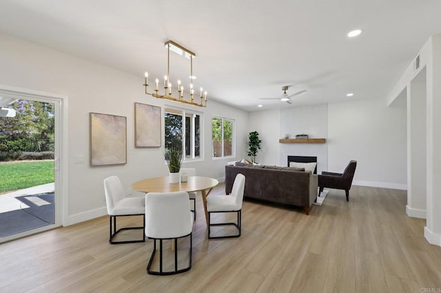 5471 Papagallo Dr, Oceanside, CA 92057 - dining room with light wood-type flooring, a fireplace, recessed lighting, and ceiling fan
