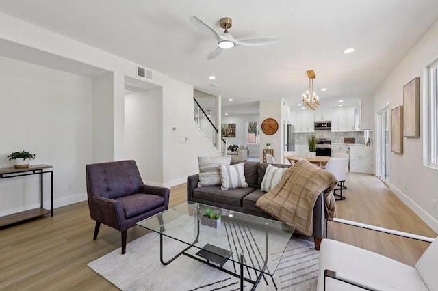 5471 Papagallo Dr, Oceanside, CA 92057 - living room with stairway, light wood-style floors, a chandelier, recessed lighting, and a ceiling fan