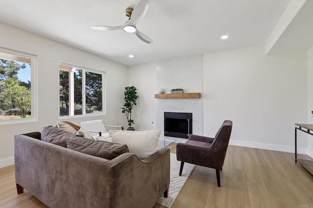 5471 Papagallo Dr, Oceanside, CA 92057 - living room featuring light wood finished floors, ceiling fan, a large fireplace, and recessed lighting