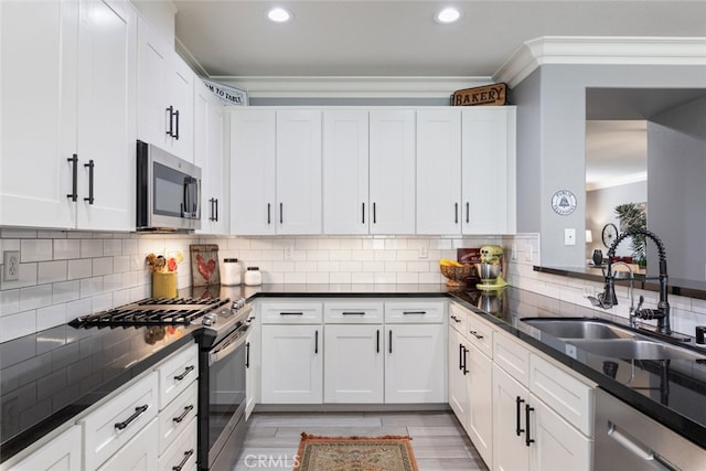 31735 Mesa View Dr, Menifee, CA 92584 - kitchen with appliances with stainless steel finishes, ornamental molding, recessed lighting, white cabinets, and decorative backsplash