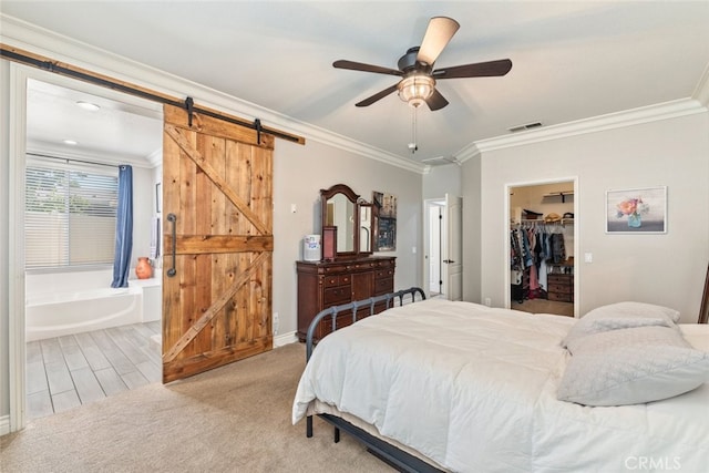 31735 Mesa View Dr, Menifee, CA 92584 - bedroom with a barn door, crown molding, a walk in closet, a closet, and carpet floors