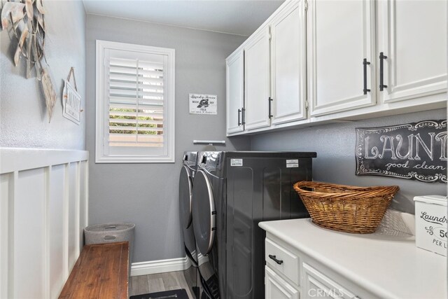 31735 Mesa View Dr, Menifee, CA 92584 - laundry room featuring cabinet space, separate washer and dryer, and wood finished floors