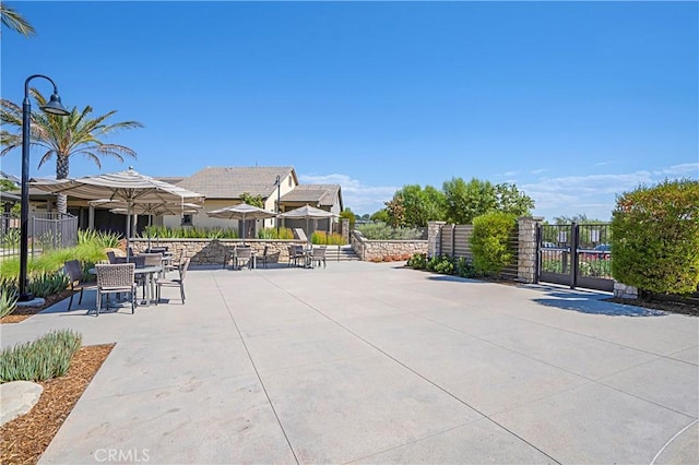 32813 Brunello Way, Temecula, CA 92591 - view of property's community with a gate, a patio, and outdoor dining area