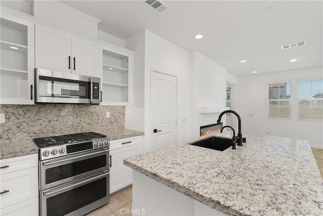 32813 Brunello Way, Temecula, CA 92591 - kitchen featuring stainless steel appliances, open shelves, white cabinets, and recessed lighting