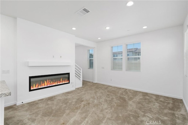 32813 Brunello Way, Temecula, CA 92591 - unfurnished living room with a glass covered fireplace, carpet floors, and recessed lighting
