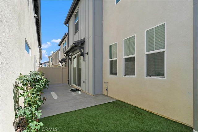 32813 Brunello Way, Temecula, CA 92591 - rear view of property with a patio area, board and batten siding, and stucco siding