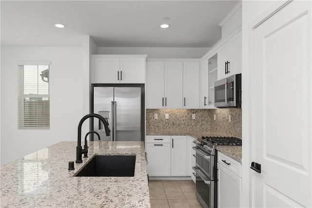 32813 Brunello Way, Temecula, CA 92591 - kitchen featuring stainless steel appliances, white cabinets, backsplash, light stone countertops, and recessed lighting