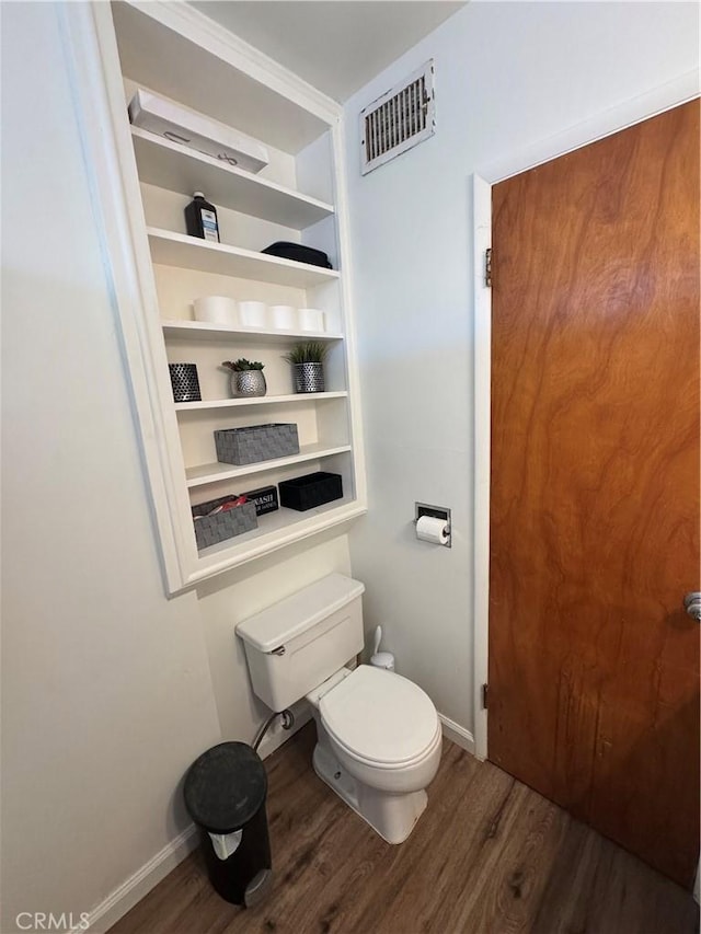 1004 Paloma St, Bakersfield, CA 93304 - bathroom featuring wood finished floors and toilet