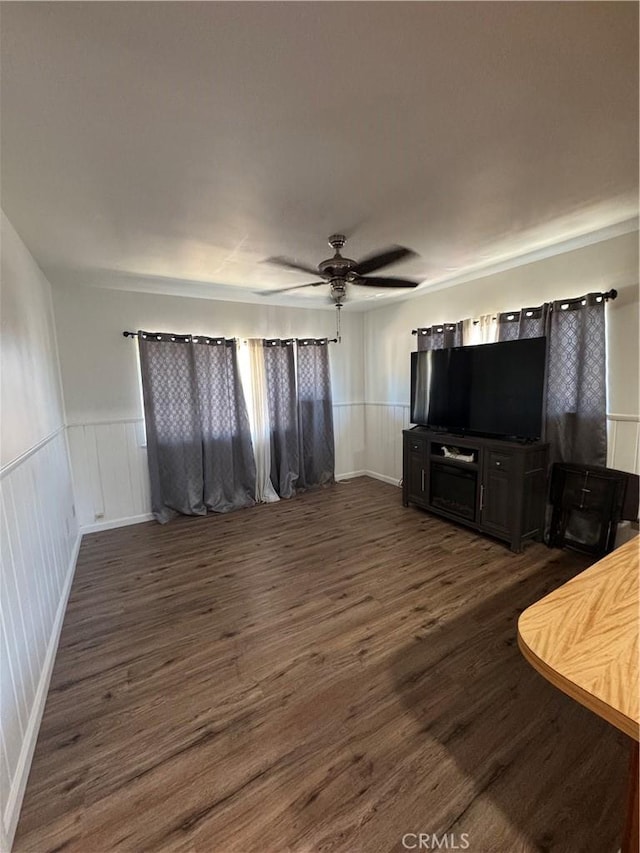 1004 Paloma St, Bakersfield, CA 93304 - living area featuring ceiling fan, dark wood-style floors, a wainscoted wall, and a decorative wall
