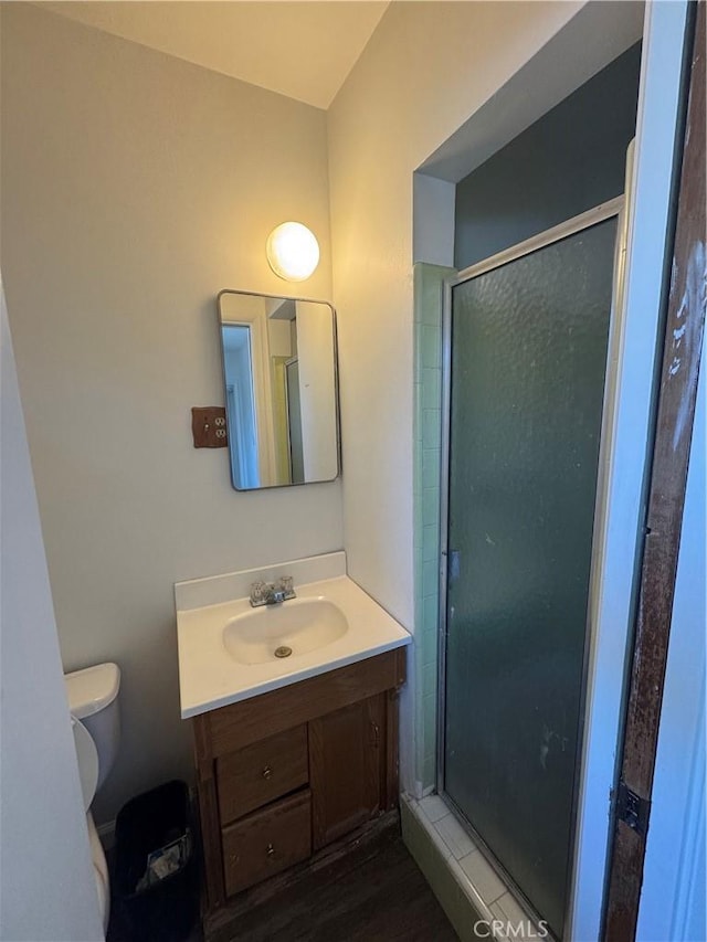1004 Paloma St, Bakersfield, CA 93304 - bathroom with vanity, a shower stall, and wood finished floors