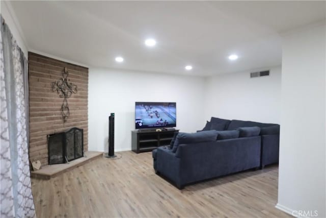 1004 Paloma St, Bakersfield, CA 93304 - living area with wood finished floors, recessed lighting, and a brick fireplace
