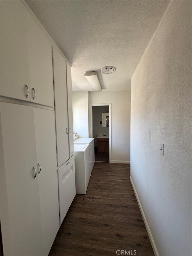1004 Paloma St, Bakersfield, CA 93304 - hallway with washer and dryer, dark wood-style floors, and a textured ceiling