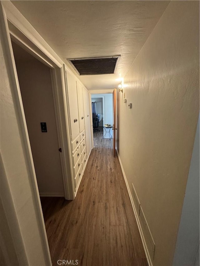 1004 Paloma St, Bakersfield, CA 93304 - hallway featuring dark wood-style flooring and baseboards