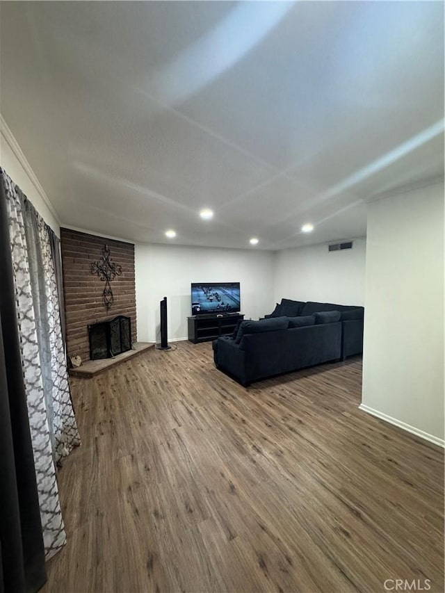 1004 Paloma St, Bakersfield, CA 93304 - living area with a brick fireplace, wood finished floors, and recessed lighting