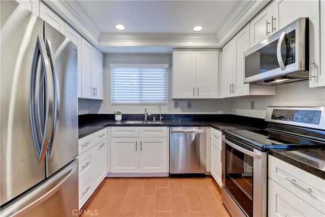 5371 Punta Alta Unit 2G, Laguna Woods, CA 92637 - kitchen featuring stainless steel appliances, white cabinets, dark countertops, ornamental molding, and recessed lighting