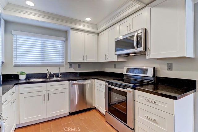 5371 Punta Alta Unit 2G, Laguna Woods, CA 92637 - kitchen featuring appliances with stainless steel finishes, crown molding, white cabinets, dark countertops, and recessed lighting